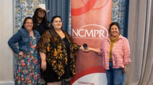 CCTC Marketing and Communications team standing with NCMPR banner with silver medallion award
