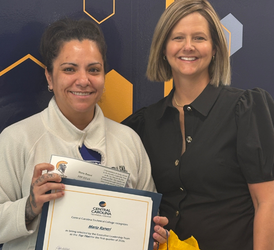 Maria Raneri, 2026 1st quarter top titan standing with CCTC president Dr. Wilbanks
